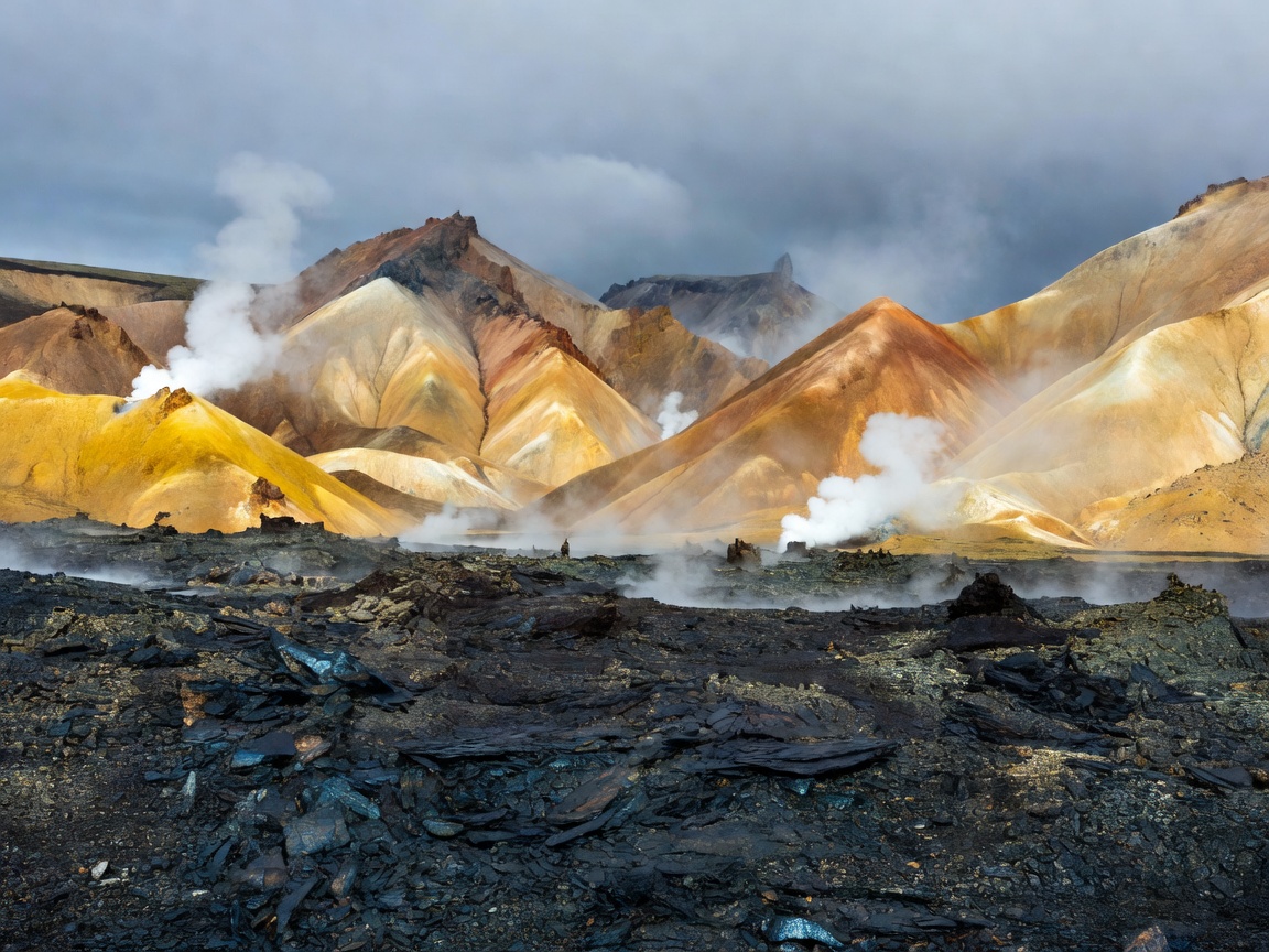 Icelandic rhyolite hills showing steam vents and green moss valleys
